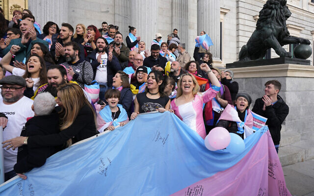People celebrate the new Transgender Law on the steps of the parliament in Madrid, Spain, December 22, 2022. (AP Photo/Paul White)