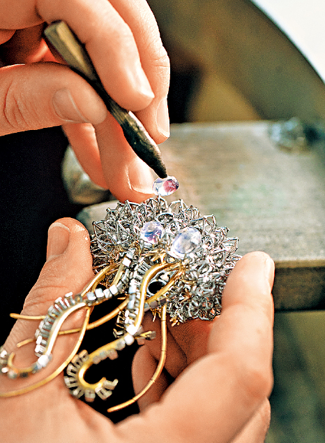 仔细地将3颗月光石镶嵌在适当位置。