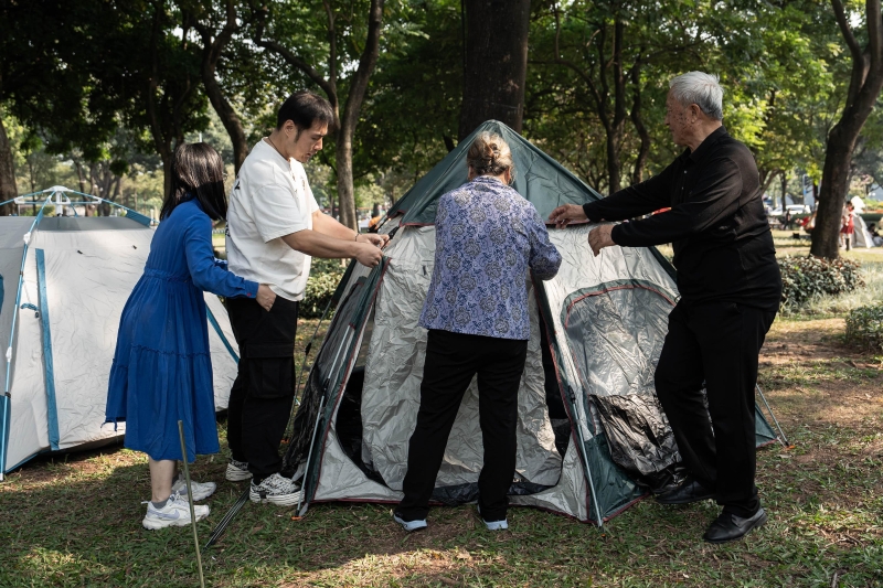 一家人在二沙岛大草坪上搭建帐篷