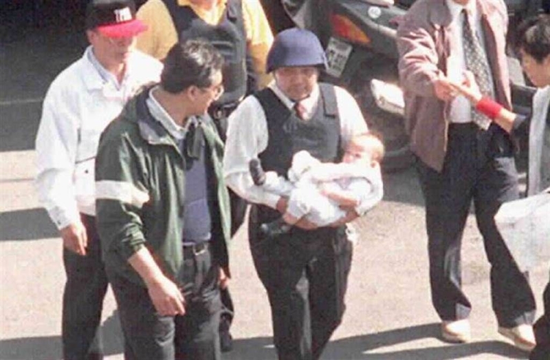 1997年挟持南非武官案，侯友宜抱着武官幼子离开官邸的照片。