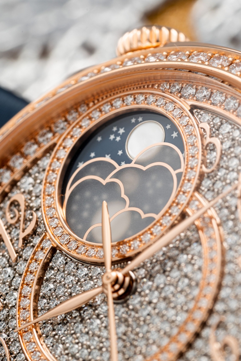 镶钻表盘以白金制，圆环以粉红金制，贝母制月亮在磨砂蓝宝石制的云下。