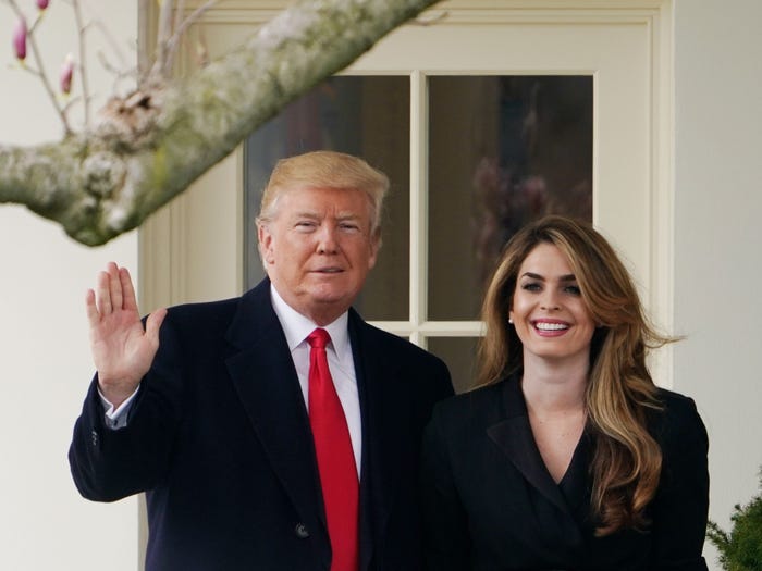 US President Donald Trump poses with former communications director Hope Hicks shortly before making his way to board Marine One on the South Lawn and departing from the White House on March 29, 2018.