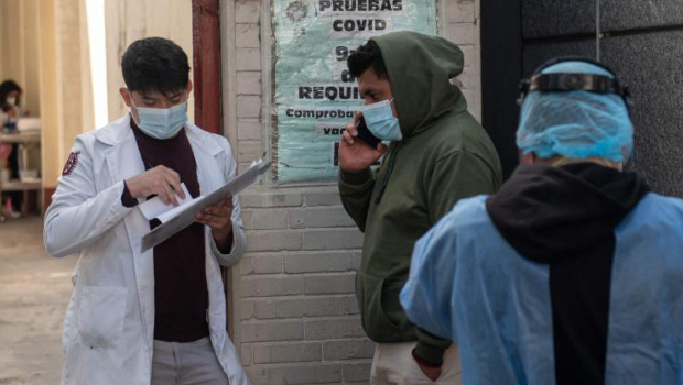 A man waits in line to get tested for Covid-19 outside a hospital in Mexico City, on December 16, 2022.
