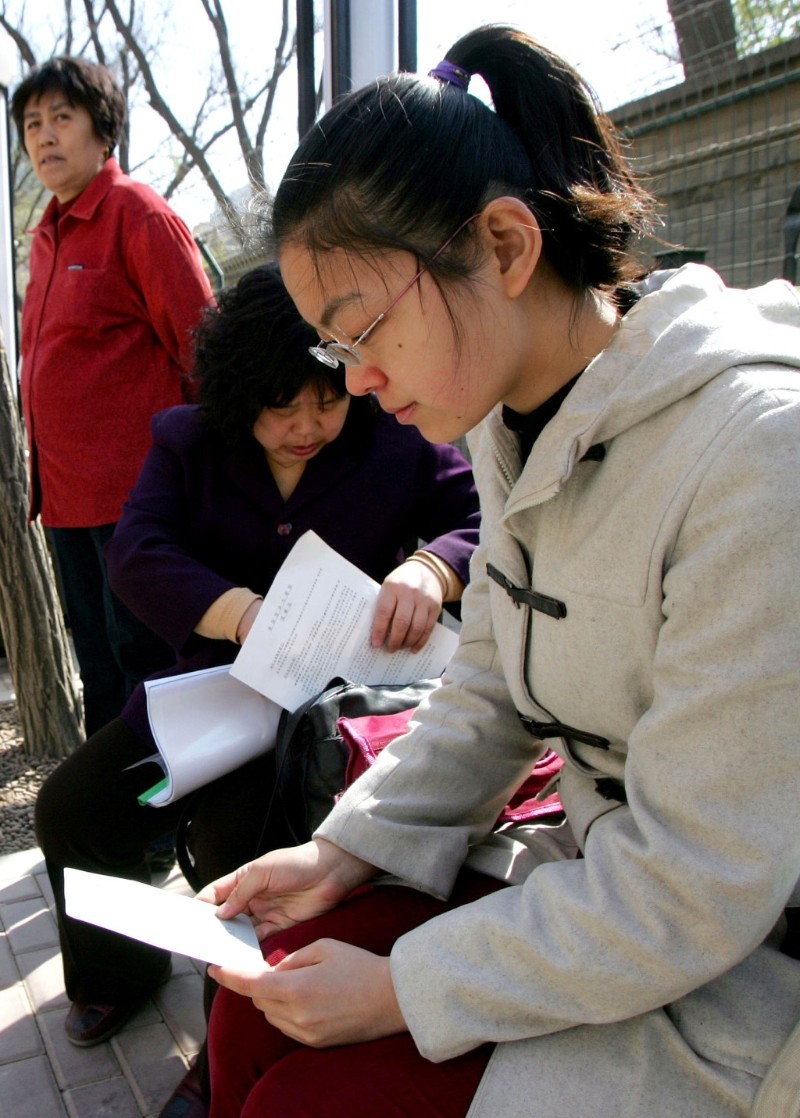 一名大學生在美國駐北京大使館外等候申請簽證。 美聯社