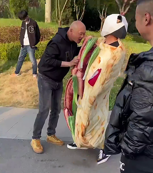 旅客对真人装扮的淄博烧烤三件套表示好奇 旅客对真人装扮的淄博烧烤三件套表示好奇