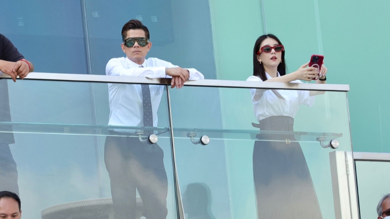 两人上身都是白色，下身则是黑色长裙、长裤，配好情侣装出场。