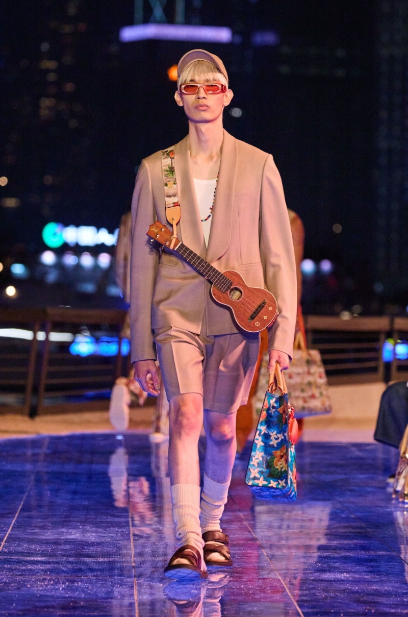 休闲西装短裤，配以一个迷你LV结他，令人产生放工即刻去度假的冲动。