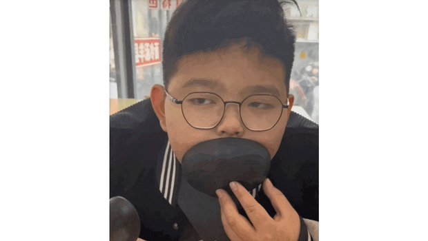 男孩拿碗捂脸点头的画面 男孩拿碗捂脸点头的画面