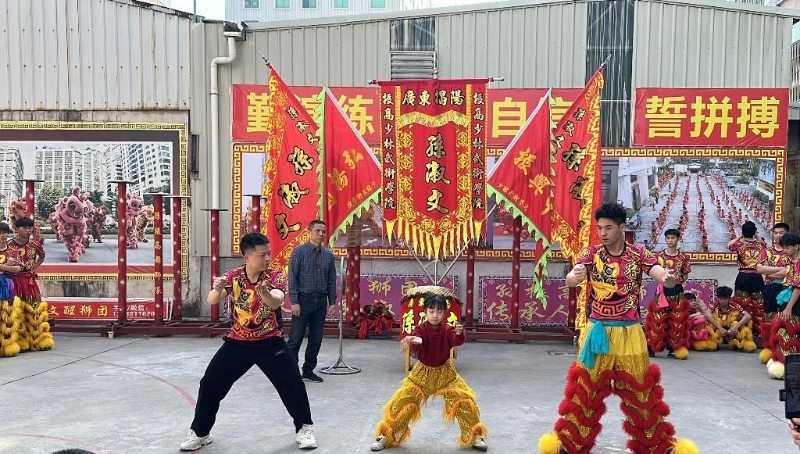 在舞狮队队员的指导下学习技巧与要领