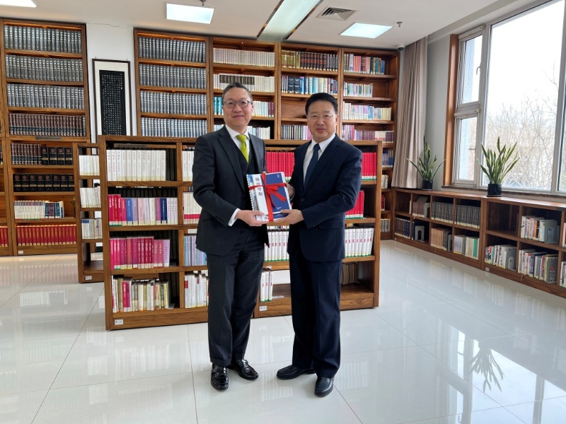 林定国（左）向童建明（右）致送纪念品。