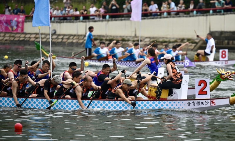 比赛中，星岛龙舟队的队员都奋力划桨。
