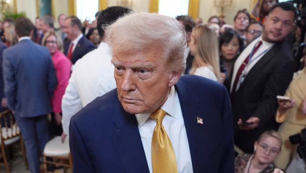 美国总统特朗普在白宫东厅签署法案后离开现场。